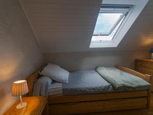 a small bedroom with a bed and a skylight at Maison Le Palais, 4 pièces, 6 personnes - FR-1-418-116 in Le Palais