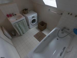 a bathroom with a washing machine and a sink at Maison Le Palais, 4 pièces, 6 personnes - FR-1-418-116 in Le Palais