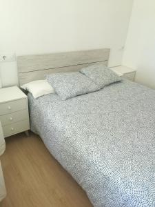Apartamento Castelo de Santa Cruz في أوليروس: غرفة نوم عليها سرير ووسادتين