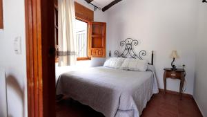 a bedroom with a bed and a window at Villas El Cañuelo in Monturque