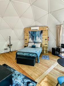 a bedroom with a bed in a tent at Broad River Campground Cabins & Domes in Boiling Springs