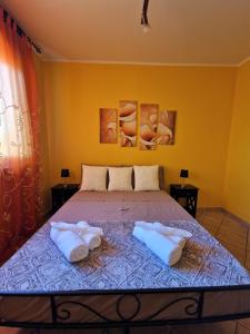a bedroom with a bed with two pillows on it at Beinasco Apartment - Le Terrazze Palace in Beinasco