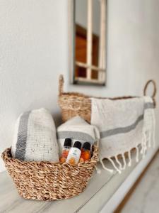 a basket sitting on a table with a mirror at Assos Gazebo Hotel in Ayvacık