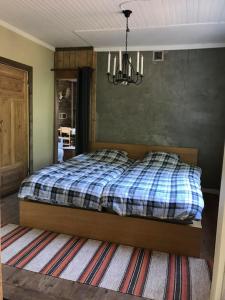 a bedroom with a bed and a chandelier at Cozy Stuga - Mountain View in Ramsele