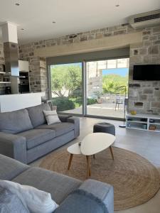 a living room with a couch and a table at Villa Lemoni in Kamilari