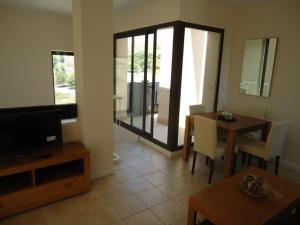 sala de estar con TV y mesa de comedor en Casa Patrick en Murcia