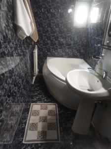 a black and white bathroom with a sink and a toilet at Montana Slănic in Slănic-Moldova +34 photos