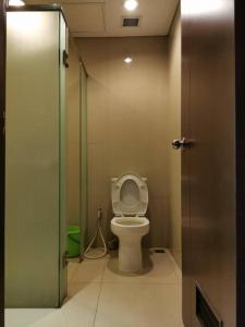 a bathroom with a toilet in a stall at Two Bedroom Apartment at el Royale Hotel in Bandung