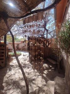a patio with a bench under a building at Hostal Sonchek in San Pedro de Atacama