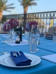 a table with a blue table cloth and a plate with a fork at Apartments MUN Petrovac in Petrovac na Moru