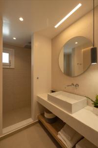 a bathroom with a sink and a mirror at KAMEO, Antiparos in Antiparos