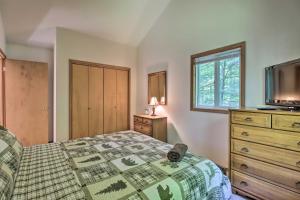 a bedroom with a bed and a dresser and a tv at Deck and Resort Amenities Pocono Lake Home in Pocono Lake