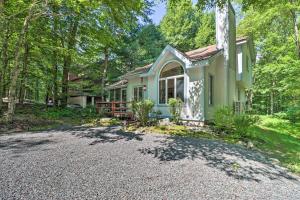 a small green house with a gravel driveway at Deck and Resort Amenities Pocono Lake Home in Pocono Lake
