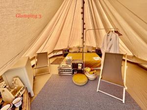 a canvas tent with a bed in it at Glamping Bieszczady z jacuzzi i basenem in Solina