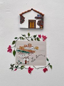 a picture of a house on a wall with flowers at La lammia di Pisticci in Pisticci