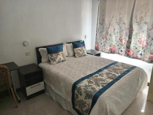 a small bedroom with a bed and a window at MATT Bed and Breakfast in Lilongwe