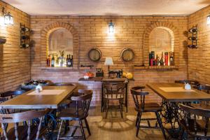 a restaurant with tables and chairs in a brick wall at Casa de Khasia in Zugdidi