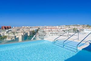 a swimming pool with a view of a city at Seashell Infinity Luxury Apartment in Estepona