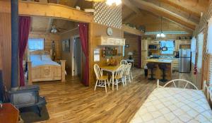 a bedroom and kitchen with a bed and a table at A Peace of Heaven Cabins and RV in Vanderpool