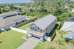 an aerial view of a house with a yard at Athenas Cottage in Butler Beach