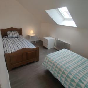 a bedroom with a bed and a skylight at Maison 3 chambres. cour Privative 2 places de parking privatives in Corquilleroy