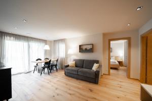 a living room with a couch and a table at Oberzerod Apartments in Siusi