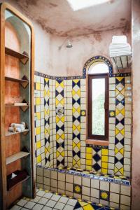 a bathroom with a blue tile floor and tile walls at Zamas Hotel in Tulum