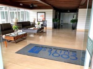 a living room with a sign that reads the price of a house at Dan's Cool Suites Tagaytay in Tagaytay