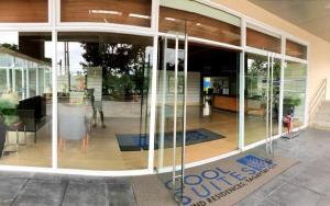 a glass entrance to a building with a sign on it at Dan's Cool Suites Tagaytay in Tagaytay
