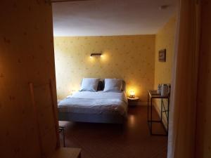 a bedroom with a bed with two pillows at Au coeur du Volcantal in Laveissière