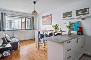 an apartment with a kitchen and a living room at Superb apartment with parking & terrace in Bordeaux center - Welkeys in Bordeaux