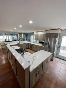 a large kitchen with a large white counter top at Libby's Cove in Carsonville