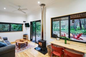 a living room with a fireplace and a wood stove at Languedoc in Stellenbosch