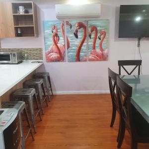 a kitchen with pink flamingos painting on the wall at de Felice in Mount Pleasant