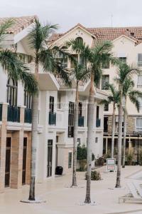 a group of palm trees in front of a building at Work-friendly Mountain-view condo near SM Seaside in Cebu City