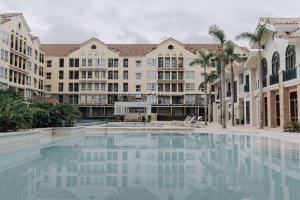 a large swimming pool in front of a building at Work-friendly Mountain-view condo near SM Seaside in Cebu City