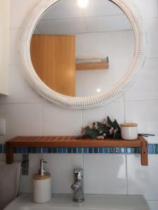 a bathroom with a mirror and a sink and a counter at Ático Love in Jerez de la Frontera