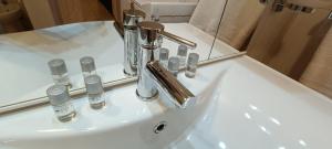 a bathroom sink with a faucet and a mirror at Appartamento Beatrice in Villanova dʼAsti