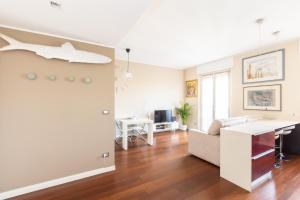 a living room with a couch and a desk at Rosselli 13 Milan Apartment in Milan