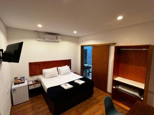 a hotel room with a bed and a television at Bistu Hotel - Vila Nova Conceição in Sao Paulo