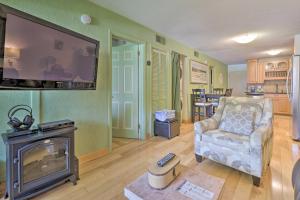 a living room with a fireplace and a tv at Hilton Head Condo with Pool and Beach Access! in Hilton Head Island