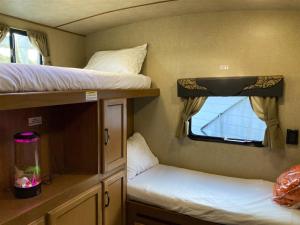 a small room with two bunk beds and a window at H - Poop Deck in Fort Bragg