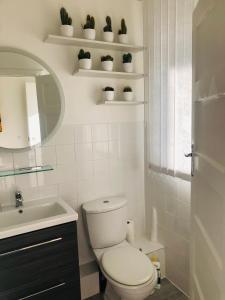 a bathroom with a toilet and a sink and a mirror at Super location 2, 1min metro 10 min from Camden in London