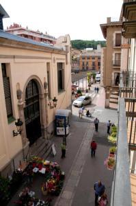 a group of people walking down a street next to buildings at Apartamentos Siglo XXI - Sant Joan in Sant Feliu de Guíxols