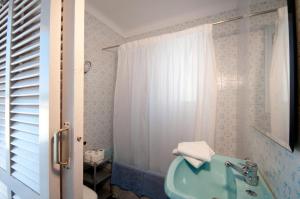 a bathroom with a blue tub and a toilet at Apartamentos Siglo XXI - Marabu in Sant Feliu de Guixols +27 photos