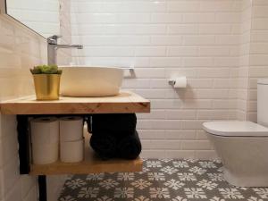 a bathroom with a sink and a toilet at Mazi Apartments Chic in Badalona