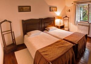 A bed or beds in a room at Casa da Padaria