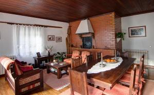 a living room with a table and a fireplace at Casa da Padaria in Piódão