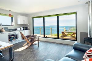 a living room with a view of the ocean at Byre 7 Aird of Sleat in Aird of Sleat