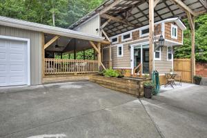a house with a porch and a garage at Blairsville Tiny Home with Covered Furnished Deck! in Blairsville